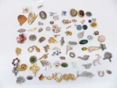 A collection of vintage brooches including silver filigree, Exquisite, Sphinx, diamanté, etc