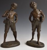 Pair of spelter figures of boys, one with books, the other with a horn, H33cm