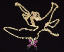 A 9ct gold necklace set with rubies and a diamond, 1.3g