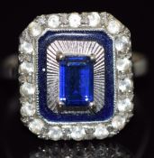 An 18ct white gold ring set with an emerald cut synthetic sapphire and paste, 3.7g, size N