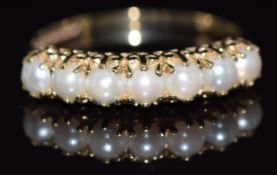 A 9ct gold half eternity ring set with split pearls, 1.7g, size N