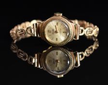 Precimax 9ct gold ladies wristwatch with gold hands and Arabic numerals, silver dial and 17 jewel