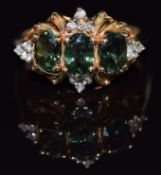 A 14k gold ring set with three oval cut green sapphires and diamonds, 3.9g, size N