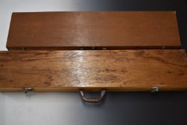 Two vintage wooden gun cases, both with fitted interiors, largest 127x26x10cm.