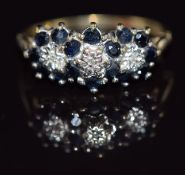 A 9ct gold ring set with diamonds and sapphires in three clusters, 2.5g, size N