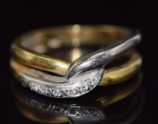 A 9ct bi-coloured gold ring set with diamonds in a twist setting, 3.9g, size K