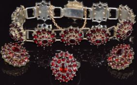A silver gilt suite of jewellery set with Bohemian cut garnets comprising bracelet, earrings & ring