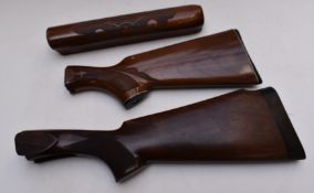Two semi-pistol grip shotgun stocks, one Remington with carved decoration and matching forend.
