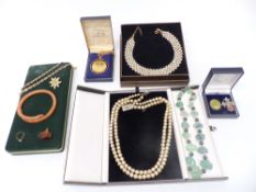 A collection of costume jewellery including two silver brooches, Art Deco snake bangle, necklaces