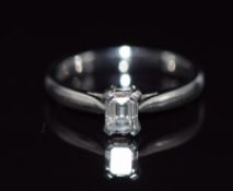 A platinum ring set with an emerald cut diamond of approximately 0.48ct, size K, 4.4g