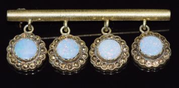 A 9ct gold bar brooch set with opal doublets and marcasite, 10.4g, 5cm long