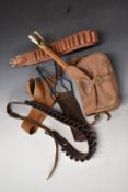 Brady canvas and leather shotgun cartridge bag together with two leather cartridge belts, three