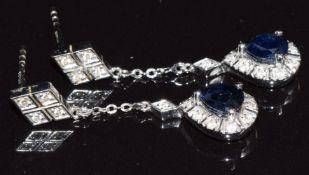 A pair of 18ct white gold earrings set with a pear cut sapphire and diamonds, 3.1g