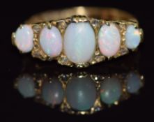 An 18ct gold ring set with five opal cabochons and rose cut diamonds, Birmingham 1903, 6.2g, size Q