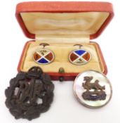 A pair of silver cufflinks set with enamel, an RAF brooch, and an RAF badge
