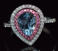 An 18ct white gold ring set with a pear cut aquamarine surrounded by pink sapphires and diamonds,