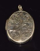 A 9ct gold locket with engraved decoration, 11.9g
