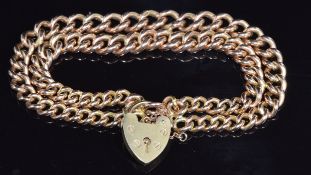 A 9ct gold double strand curb link bracelet made from a Victorian fob chain, with heart padlock,