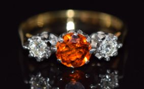 An 18ct gold ring set with a round cut garnet and diamonds, 2.4g, size K