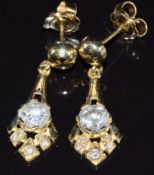 A pair of 14ct gold earrings set with diamonds of approximately 0.71ct & 0.78ct, with certificates