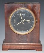 A mahogany cased military style mantel clock with stop/start, black dial, white hands and makers and