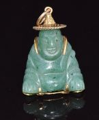 A 14k gold pendant set with aventurine quartz in the form of a Buddha