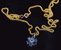 A 9ct gold pendant set with a yellow sapphire and blue sapphires forming a flower cluster, 9.4g