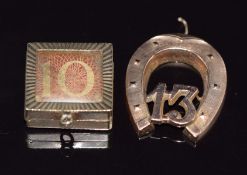 A 9ct rose gold pendant/ charm in the form of a horseshoe and 13 and a 9ct gold locket/ charm with a