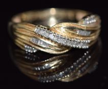 A 14k gold ring set with diamonds in a twist setting, 2.2g, size P
