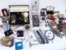 A collection of costume jewellery brooches, agate necklace, Sarah Coventry ring, bracelets including