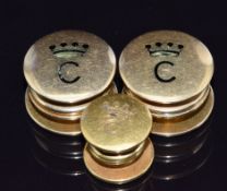 Three yellow metal clip on studs with an initial and crown, the smallest example marked 