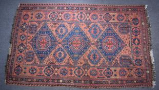 Turkoman rug decorated with three large blue guls on a wine ground, 310 x 192cm