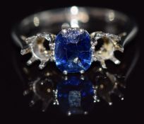 An 18ct white gold ring set with a cushion cut sapphire of approximately 0.75cts in a platinum