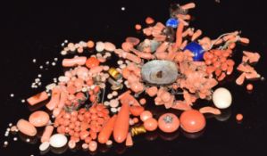 A collection of loose coral sections and cabochons