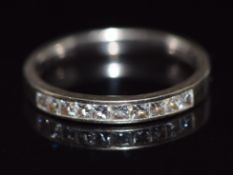 An 18ct white gold half eternity ring set with 10 princess cut diamonds, 3.6g, size N