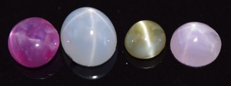 Two pink star sapphires, a blue star sapphire and a chatoyant green sapphire, 1.7g