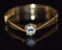 An 18ct gold ring set with a diamond, 2.6g