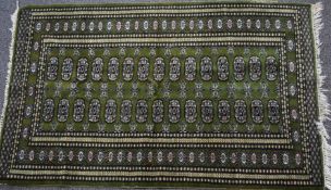 Turkoman rug on green ground, 150 x 90cm