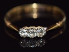 An 18ct gold ring set with three diamonds, 1.8g, size Q/R