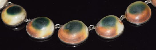 A Victorian silver necklace set with Operculum shells and a matching ring