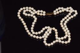 A double strand cultured pearl necklace with a 9ct gold claps