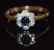 An 18ct gold ring set with a sapphire surrounded by diamonds, 2.3g, size O