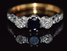 An 18ct gold ring set with a sapphire and diamonds in a platinum setting, 3.5g, size L/M