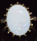 A 9ct gold ring set with an oval cut white opal, 4.5g, size O