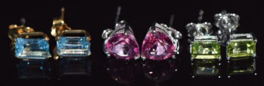 Two pairs of 9ct white gold earrings set with topaz and peridot and a pair of 9ct gold earrings