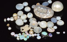A collection of loose mother of pearl and loose opal cabochons