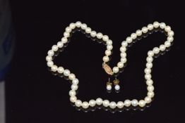 A single stand of cultured pearls with a 9ct gold clasp and a pair of pearl earrings