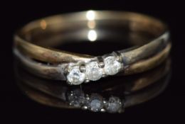A 9ct gold ring set with three diamonds in a twist setting, 1.5g, size O