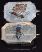 A pair of silver brooches set with a variety of agate, one depicting a fly the other a butterfly,