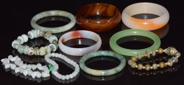 Three beaded jadeite bracelets, two jadeite bangles and three agate bangles